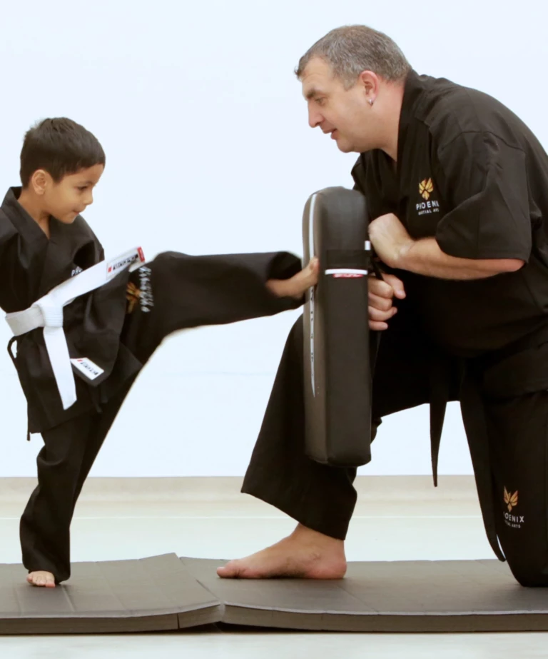 Karate child kicking pad